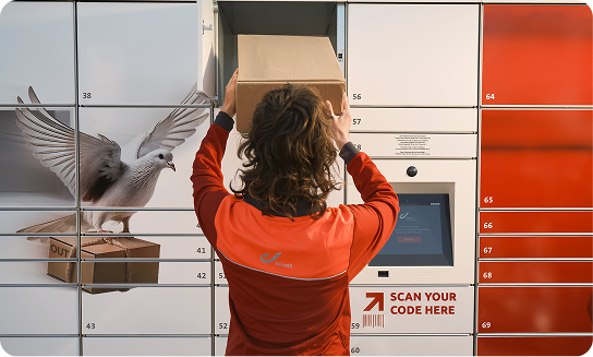 A Bpost employee placing a parcel in a Bbox